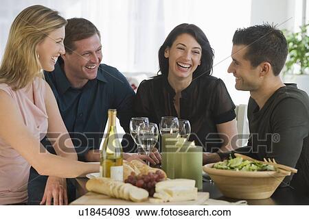 Couples sitting around wine, bread, cheese, and salad View Large Photo Image Stock Image - Couples sitting around wine, bread, cheese, and salad. Fotosearch