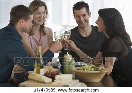 Stock Photo - Couples toasting with wine glasses. Fotosearch