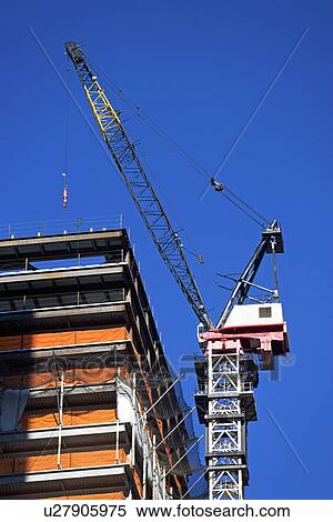 Crane above construction building View Large Photo Image Stock Photography - Crane above construction building. Fotosearch