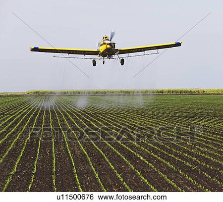 Stock Photograph - crop-duster plain over field. Fotosearch