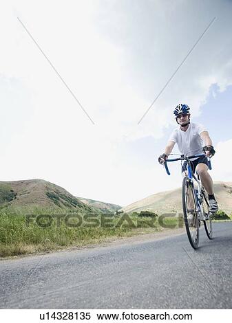 Stock Photography - Cyclist on country road. Fotosearch