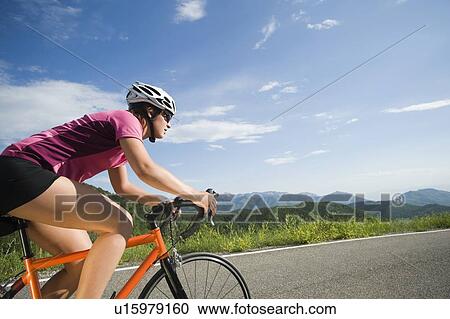 Stock Image - Cyclist on mountain road. Fotosearch
