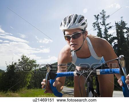 Stock Image - Cyclist on mountain road. Fotosearch