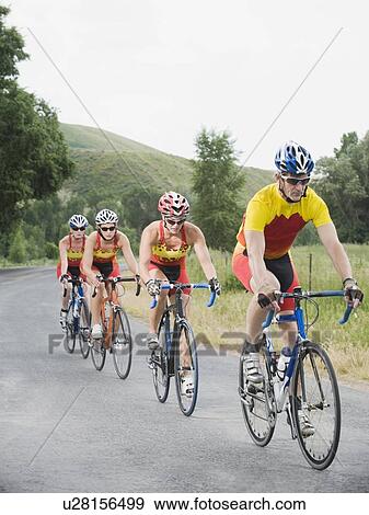 Stock Photo - Cyclists in a row on country road. Fotosearch