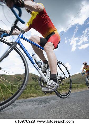 Cyclists on country road View Large Photo Image Stock Photo - Cyclists on country road. Fotosearch