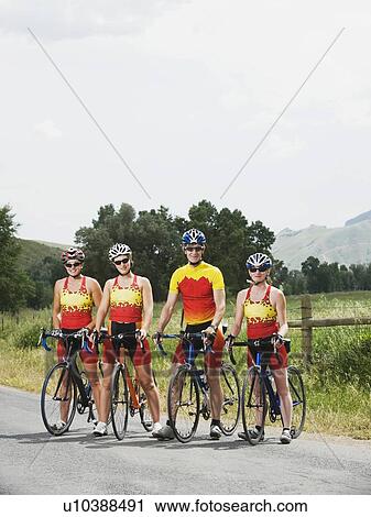 Stock Image - Cyclists posing on country road. Fotosearch