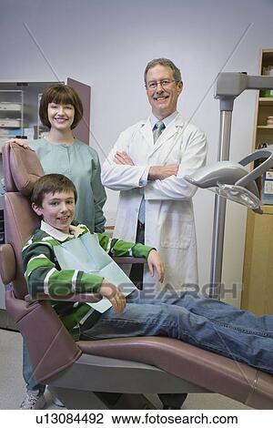 Dentist and dental hygienist with patient View Large Photo Image Stock Image - Dentist and dental hygienist with patient. Fotosearch