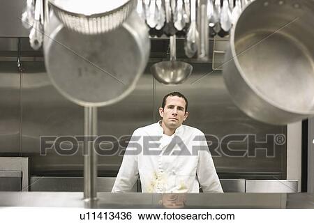 Stock Photograph - Dirty chef leaning against stove. Fotosearch
