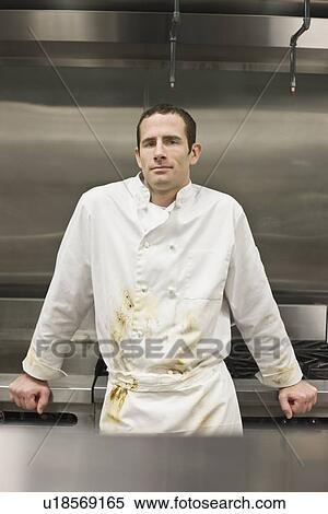 Stock Photography - Dirty chef leaning against stove. Fotosearch