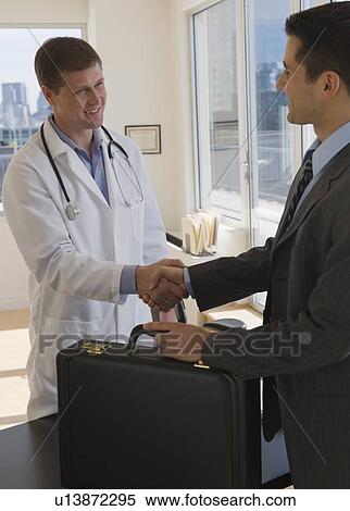 Stock Photography - Doctor and businessman shaking hands. Fotosearch