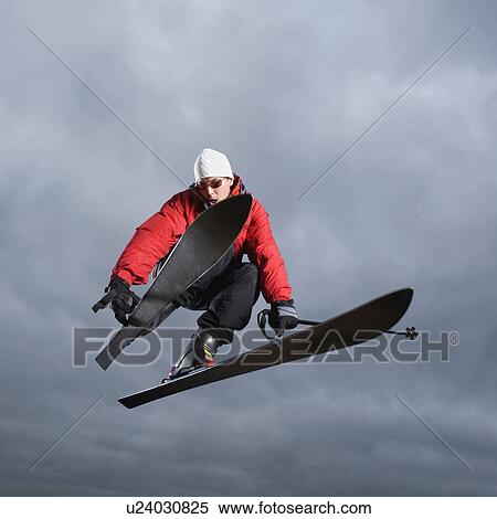 Downhill skier in mid-air View Large Photo Image Stock Photography - Downhill skier in mid-air. Fotosearch