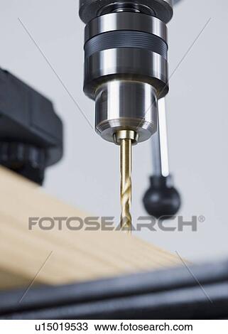 Stock Image - Drill press and wood. Fotosearch