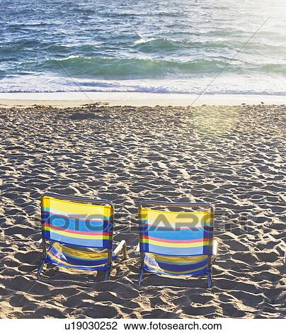 Empty beach chairs on sand View Large Photo Image Stock Image - Empty beach chairs on sand. Fotosearch