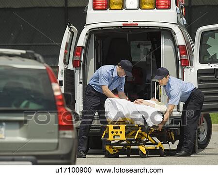 EMTs loading patient into ambulance View Large Photo Image Stock Image - EMTs loading patient into ambulance. Fotosearch