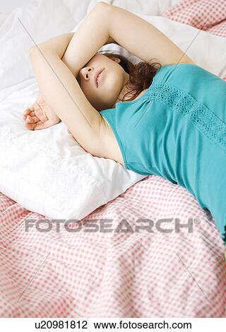 Exhausted teenage girl sleeping on bed View Large Photo Image Stock Image - Exhausted teenage girl sleeping on bed. Fotosearch