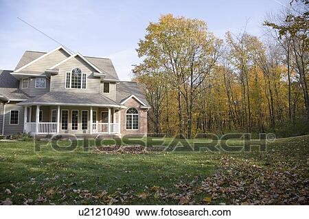 Stock Image - Facade of house in autumn. Fotosearch