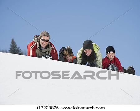 Family laying in snow View Large Photo Image Stock Photograph - Family laying in snow. Fotosearch