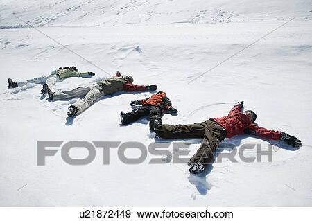 Stock Photo - Family making snow angels. Fotosearch