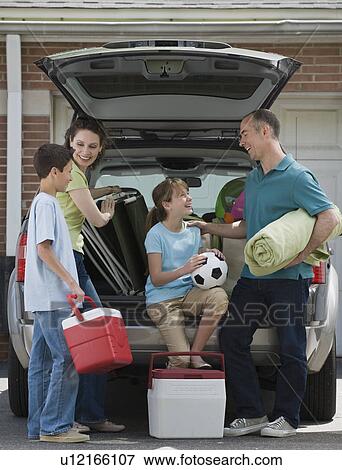 Stock Photo - Family packing car for vacation. Fotosearch