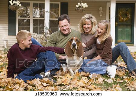 Family petting dog outdoors View Large Photo Image Stock Image - Family petting dog outdoors. Fotosearch
