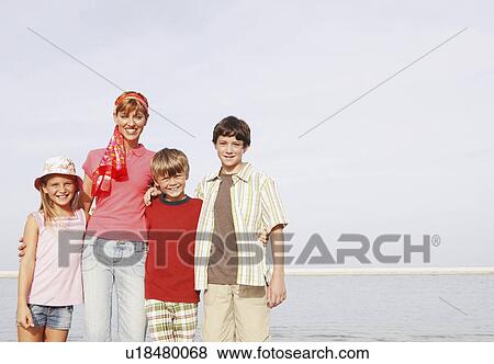 Stock Photo - Family posing on beach. Fotosearch