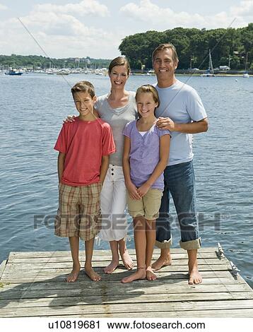 Stock Image - Family posing together on dock. Fotosearch