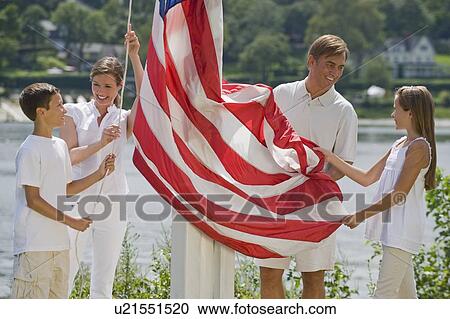 Family raising American flag together View Large Photo Image Stock Image - Family raising American flag together. Fotosearch