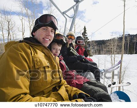 Family sitting on ski lift chair View Large Photo Image Stock Image - Family sitting on ski lift chair. Fotosearch