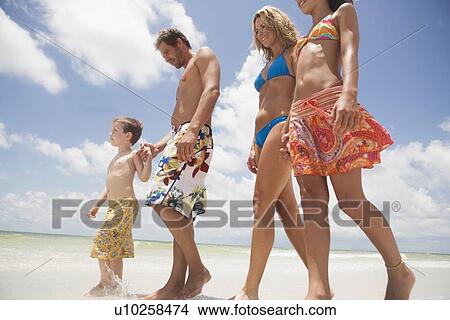 Family walking on beach View Large Photo Image Picture - Family walking on beach. Fotosearch