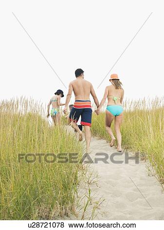 Stock Photo - Family walking on beach. Fotosearch