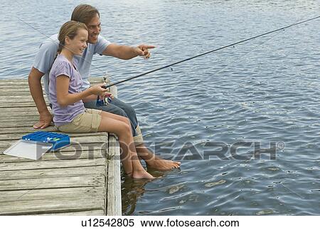 Stock Photography - Father and daughter fishing off dock. Fotosearch
