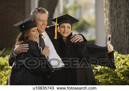 Father and graduate daughters taking own photograph View Large Photo Image Stock Image - Father and graduate daughters taking own photograph. Fotosearch