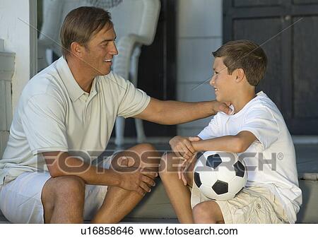 Father and son bonding on front stoop View Large Photo Image Stock Photograph - Father and son bonding on front stoop. Fotosearch