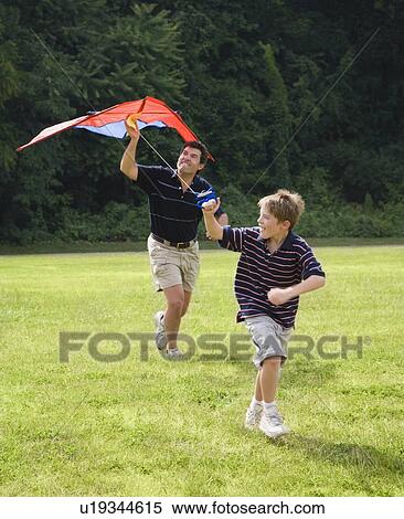 Father and son flying kite View Large Photo Image Stock Photography - Father and son flying kite . Fotosearch