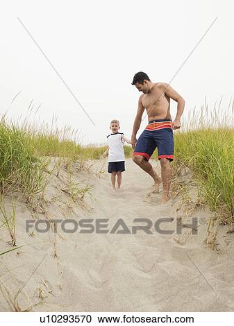 Father and son holding hands and running on beach View Large Photo Image Stock Image - Father and son holding hands and running on beach. Fotosearch