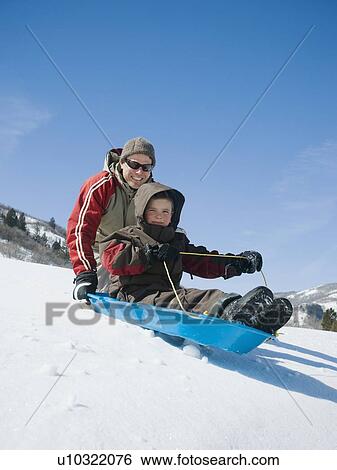 Father and son on sled View Large Photo Image Stock Photograph - Father and son on sled. Fotosearch