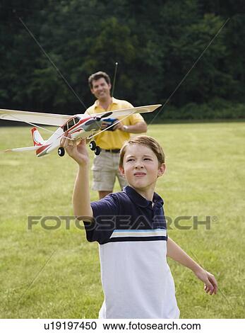 Father and son playing with remote control airplane View Large Photo Image Stock Image - Father and son playing with remote control airplane. Fotosearch