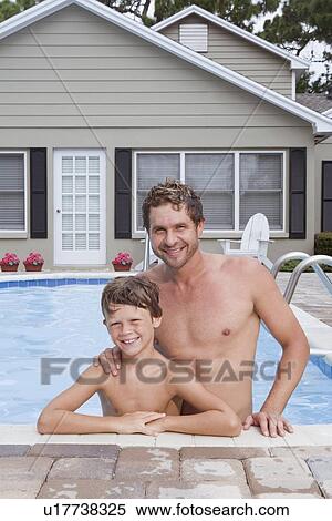 Father and son posing in swimming pool View Large Photo Image Stock Photography - Father and son posing in swimming pool. Fotosearch