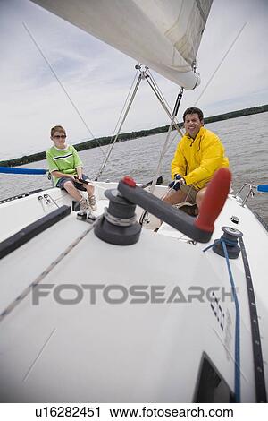 Father and son sitting on sailboat View Large Photo Image Stock Image - Father and son sitting on sailboat. Fotosearch