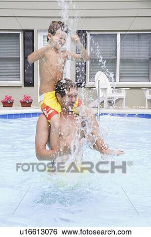 Father and son splashing in swimming pool View Large Photo Image Stock Photograph - Father and son splashing in swimming pool. Fotosearch