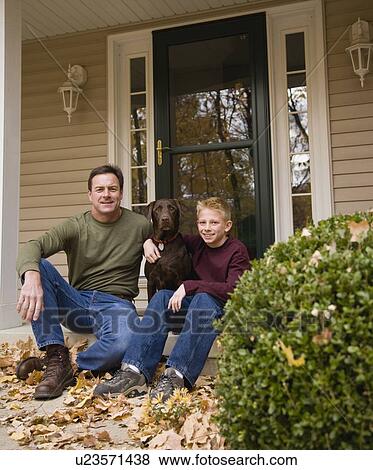 Stock Photo - Father and son with dog outdoors. Fotosearch