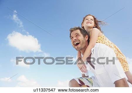 Father carrying daughter on shoulders View Large Photo Image Stock Photo - Father carrying daughter on shoulders. Fotosearch