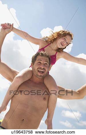 Father carrying daughter on shoulders View Large Photo Image Stock Photo - Father carrying daughter on shoulders. Fotosearch