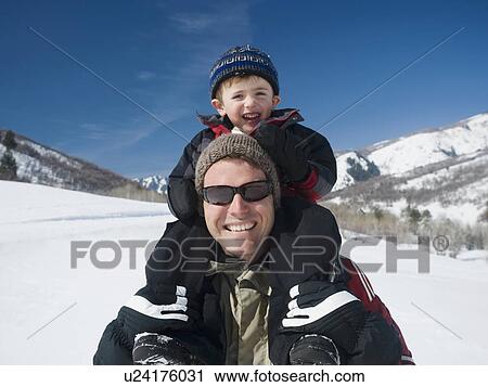 Stock Image - Father holding son on shoulders . Fotosearch