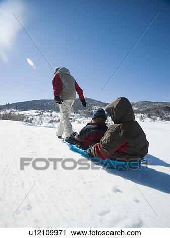 Father pulling children on sled View Large Photo Image Stock Image - Father pulling children on sled. Fotosearch