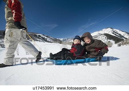 Father pulling children on sled View Large Photo Image Stock Image - Father pulling children on sled. Fotosearch
