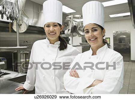 Stock Photo - Female chefs posing in kitchen. Fotosearch