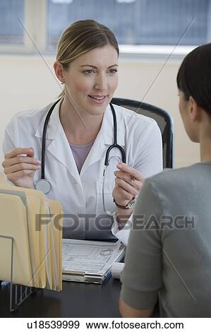 Female doctor consulting female patient View Large Photo Image Stock Photo - Female doctor consulting female patient. Fotosearch