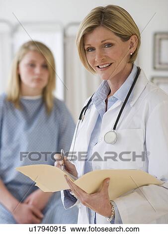 Female doctor holding chart View Large Photo Image Stock Photography - Female doctor holding chart. Fotosearch