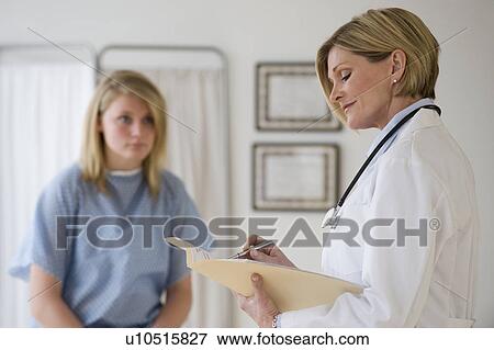 Stock Photo - Female doctor reading chart. Fotosearch